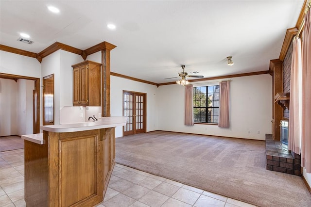 kitchen with french doors, light countertops, visible vents, light carpet, and a peninsula