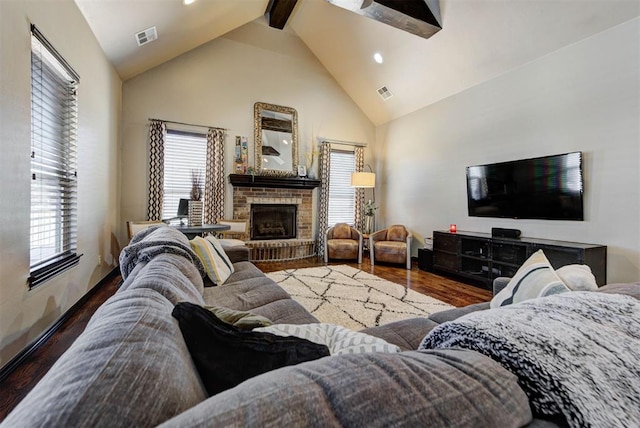 living room with high vaulted ceiling, a brick fireplace, visible vents, and wood finished floors