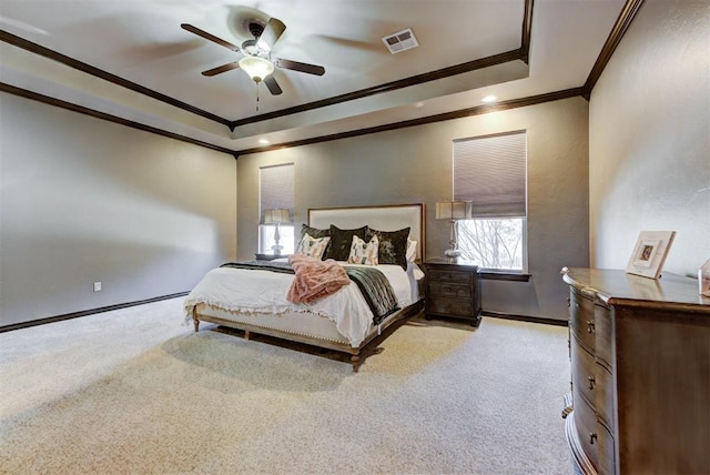 bedroom featuring baseboards, visible vents, a raised ceiling, light colored carpet, and ornamental molding