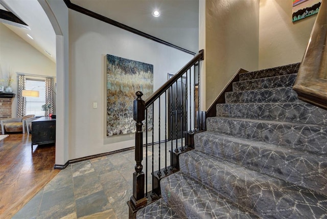 staircase featuring high vaulted ceiling, recessed lighting, crown molding, and baseboards