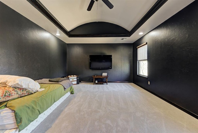 carpeted bedroom with ceiling fan, a textured wall, recessed lighting, vaulted ceiling, and a tray ceiling