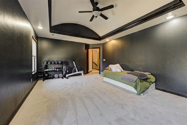 carpeted bedroom with baseboards, a textured wall, lofted ceiling, a tray ceiling, and recessed lighting