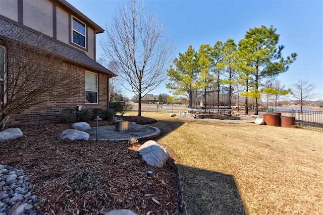 view of yard featuring a trampoline and fence