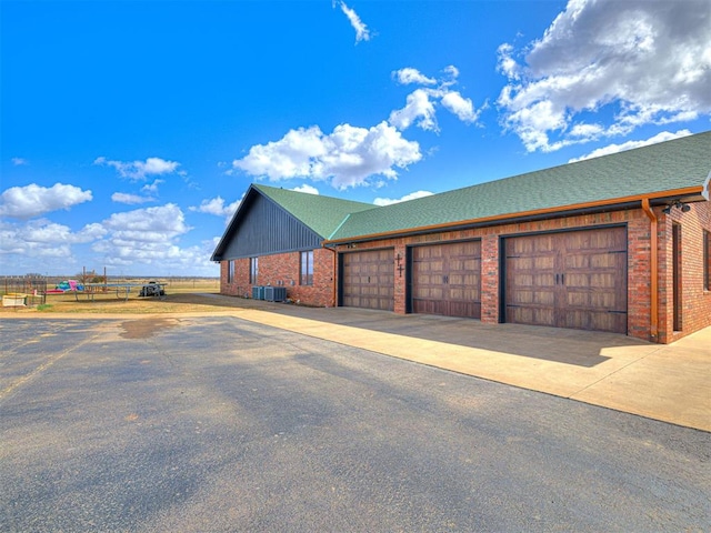 exterior space featuring driveway and brick siding