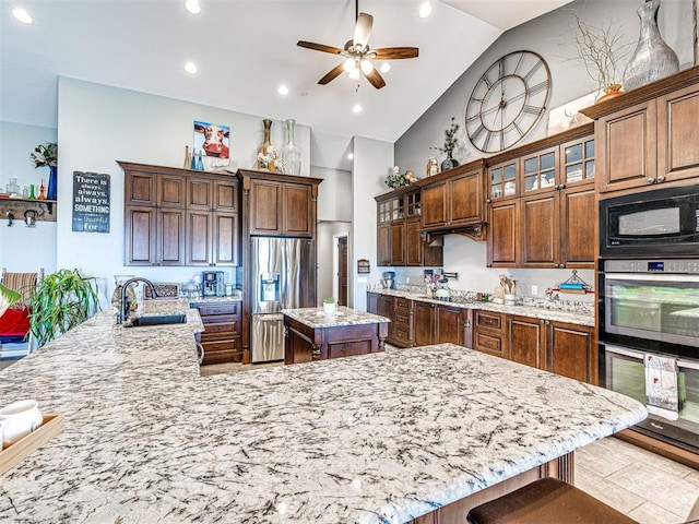 344750 E 830th Rd, Chandler, OK 74834 - kitchen with stainless steel fridge with ice dispenser, a large island, a sink, black microwave, and ceiling fan