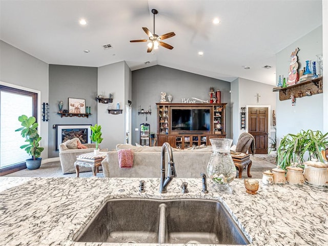 344750 E 830th Rd, Chandler, OK 74834 - kitchen featuring a sink, open floor plan, ceiling fan, vaulted ceiling, and light stone countertops