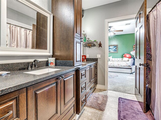 344750 E 830th Rd, Chandler, OK 74834 - ensuite bathroom with double vanity, a ceiling fan, tile patterned floors, and baseboards