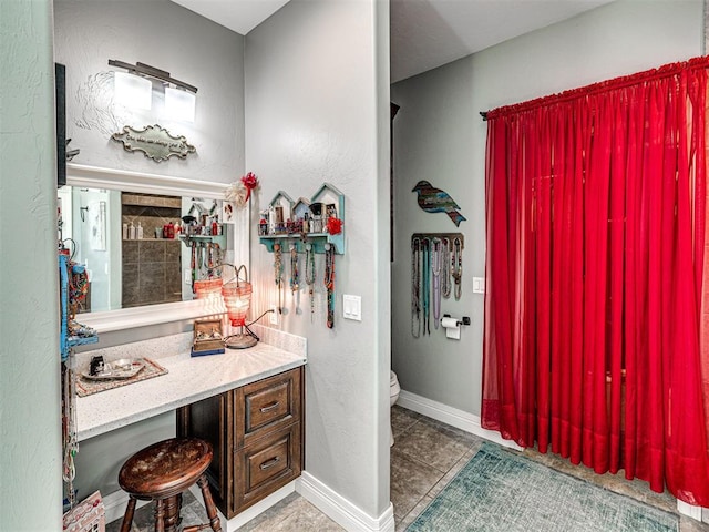 344750 E 830th Rd, Chandler, OK 74834 - bathroom featuring tile patterned flooring, toilet, vanity, a textured wall, and baseboards