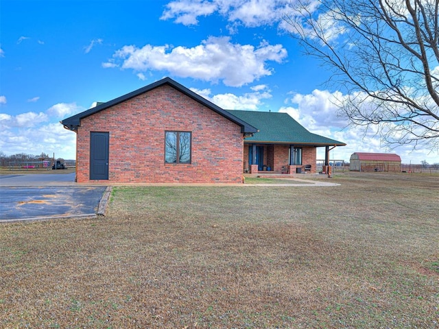 344750 E 830th Rd, Chandler, OK 74834 - back of property with brick siding, a yard, and covered porch