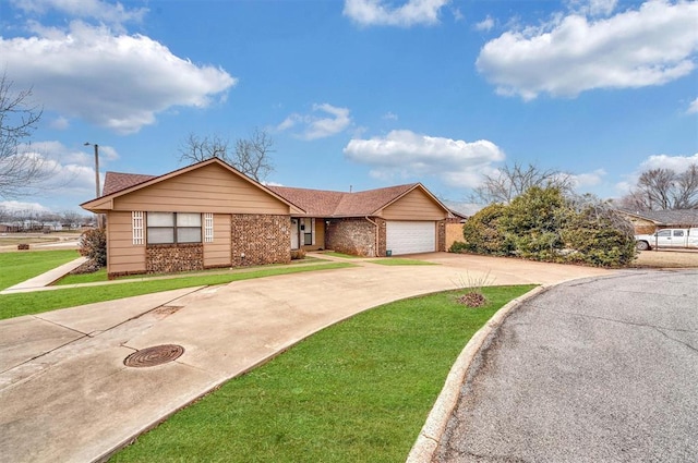 single story home with a garage, driveway, brick siding, and a front yard