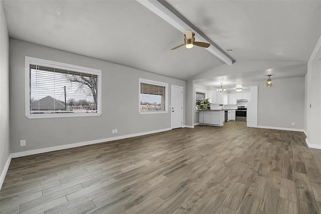 unfurnished living room featuring visible vents, baseboards, wood finished floors, vaulted ceiling with beams, and ceiling fan with notable chandelier