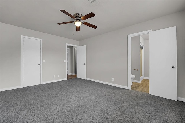 unfurnished bedroom featuring ceiling fan, carpet, connected bathroom, and baseboards