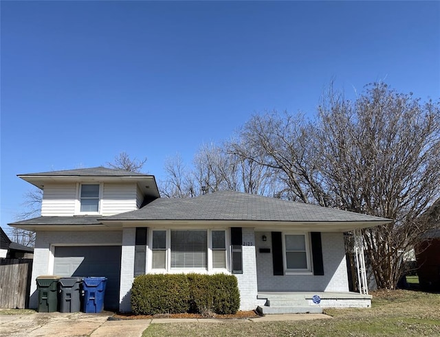 view of front of property featuring brick siding, an attached garage, and fence