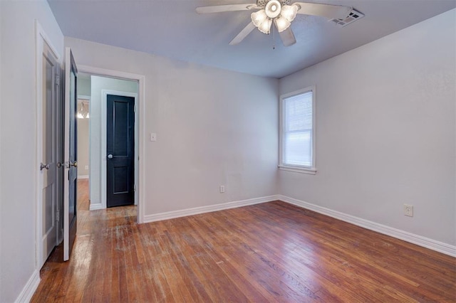 unfurnished room featuring visible vents, ceiling fan, baseboards, and hardwood / wood-style flooring