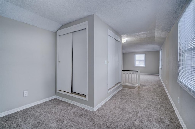 interior space with a textured ceiling and baseboards