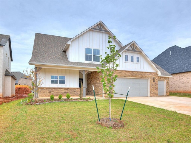 view of front facade with concrete driveway, a front lawn, board and batten siding, and brick siding