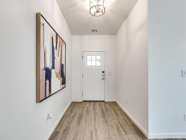 entryway featuring light wood-type flooring, visible vents, and baseboards