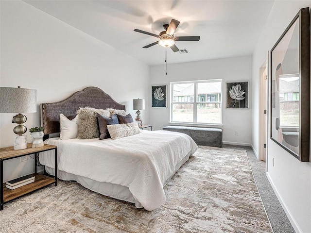 bedroom featuring ceiling fan, carpet, visible vents, and baseboards