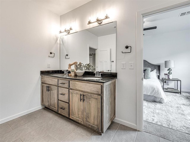 full bath with double vanity, ensuite bath, visible vents, and a sink