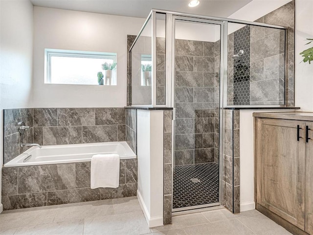 bathroom with tile patterned floors, a shower stall, and a bath