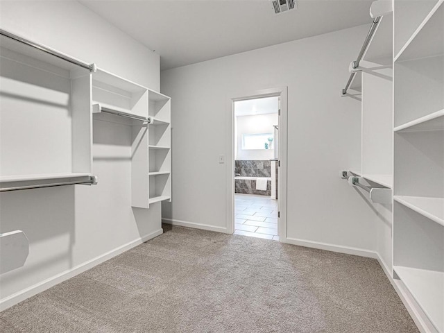 walk in closet with carpet and visible vents