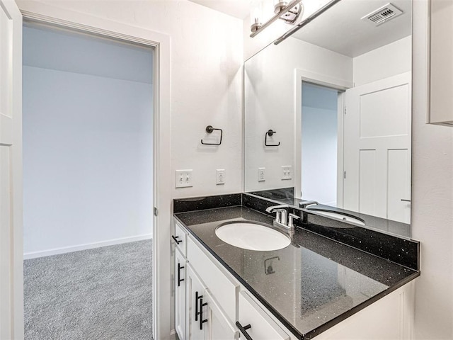 bathroom featuring baseboards, visible vents, and vanity