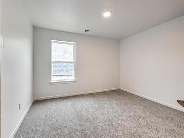 carpeted empty room with baseboards and visible vents