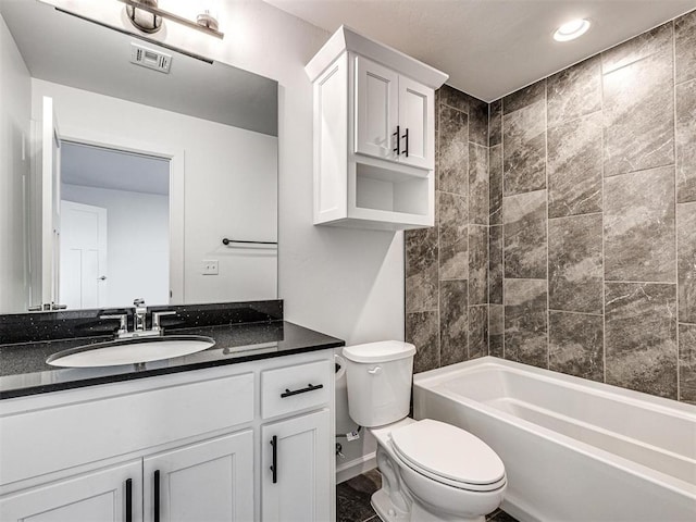 full bathroom with toilet, vanity, visible vents, baseboards, and shower / washtub combination