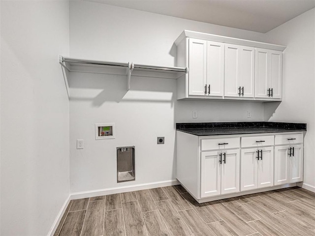 washroom featuring baseboards, wood finish floors, washer hookup, and hookup for an electric dryer