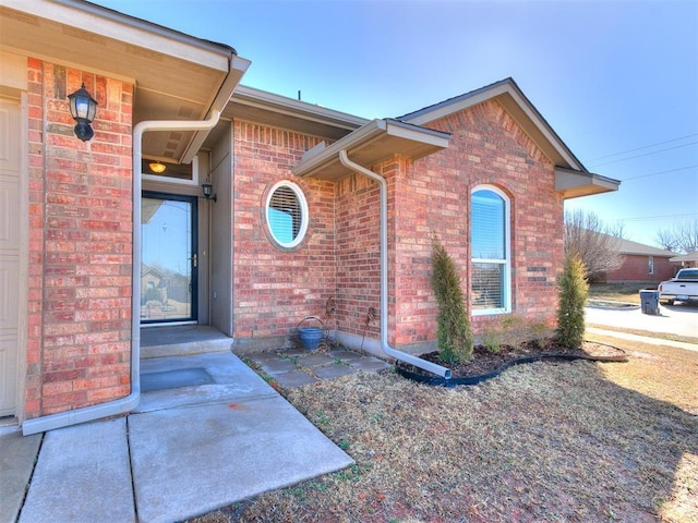 view of property exterior with brick siding