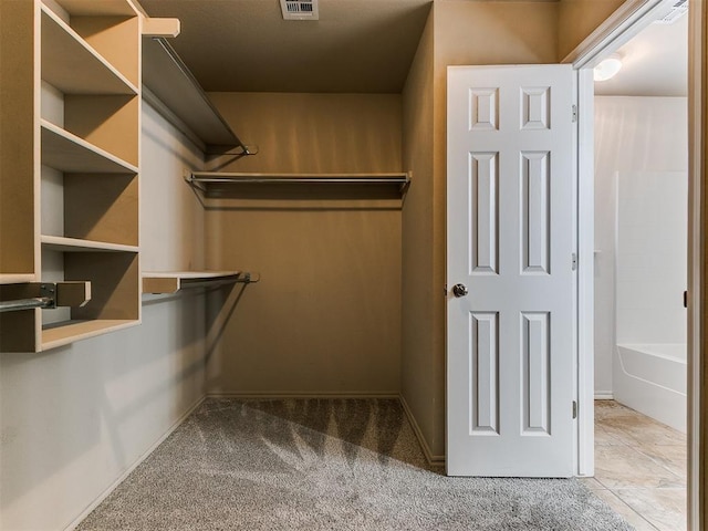 spacious closet with carpet floors and visible vents