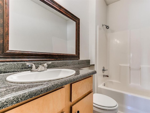 bathroom featuring bathtub / shower combination, vanity, and toilet