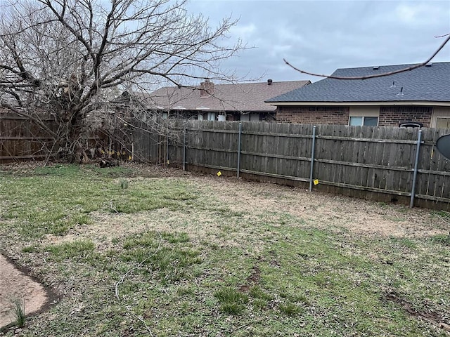 view of yard with a fenced backyard