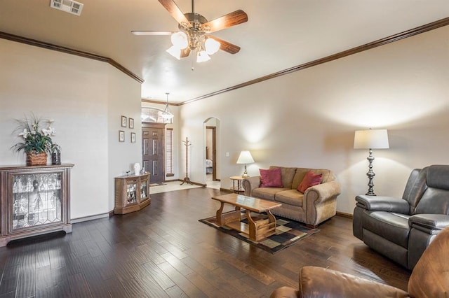 living area with baseboards, visible vents, arched walkways, wood finished floors, and crown molding