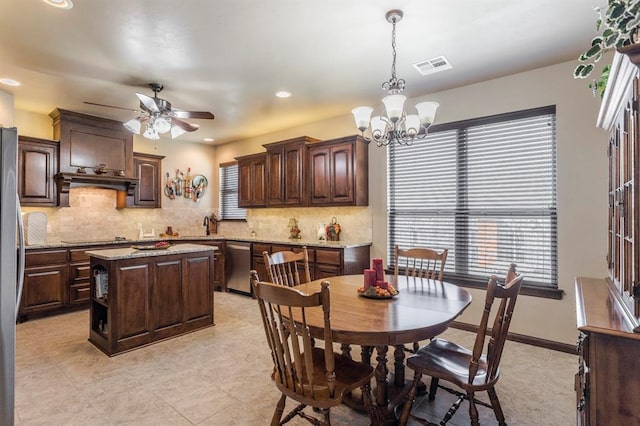 kitchen with stainless steel appliances, visible vents, dark brown cabinets, and tasteful backsplash