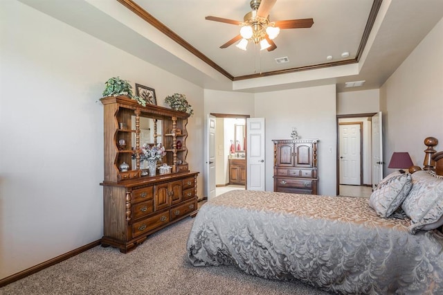 bedroom featuring a raised ceiling, visible vents, and crown molding