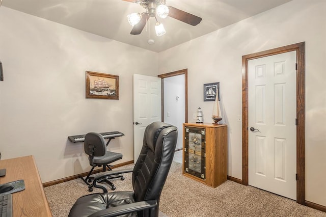 office with a ceiling fan, light colored carpet, and baseboards