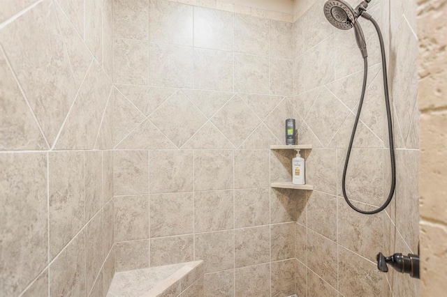 interior details featuring a tile shower