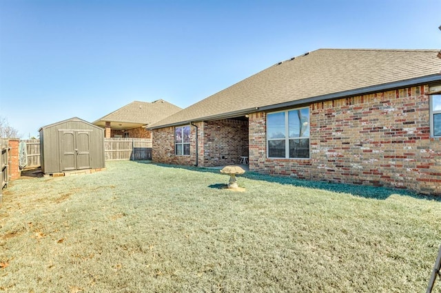 view of yard featuring a storage shed, an outdoor structure, and a fenced backyard