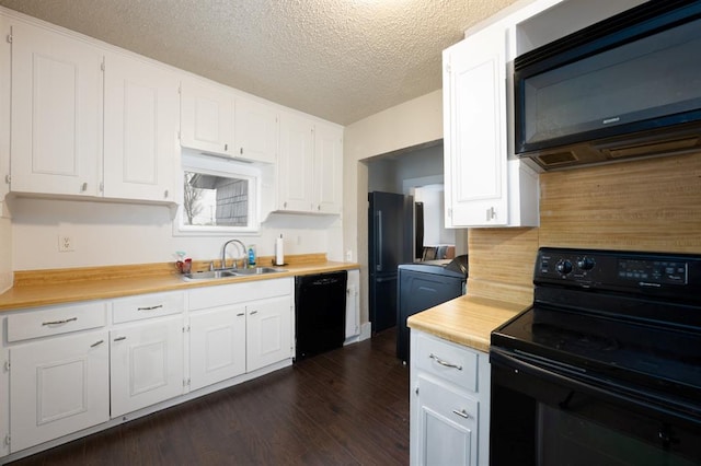 kitchen featuring white cabinets, a sink, and black appliances