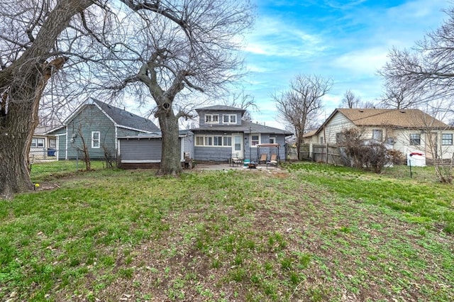 rear view of property with a patio area, fence, and a lawn