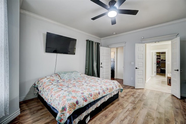 bedroom featuring baseboards, ceiling fan, wood finished floors, and crown molding