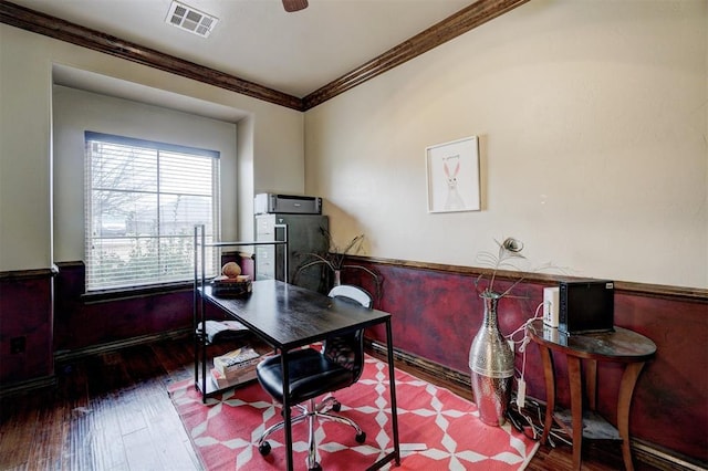 office space with wood-type flooring, visible vents, and crown molding