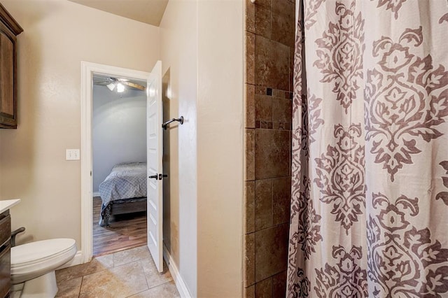 bathroom with tile patterned flooring, vanity, toilet, and a shower with curtain