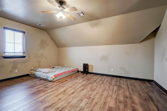 unfurnished bedroom with baseboards, visible vents, and wood finished floors