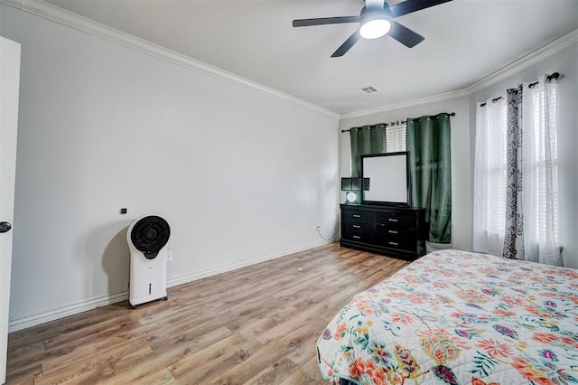 bedroom with baseboards, visible vents, light wood-style flooring, and crown molding