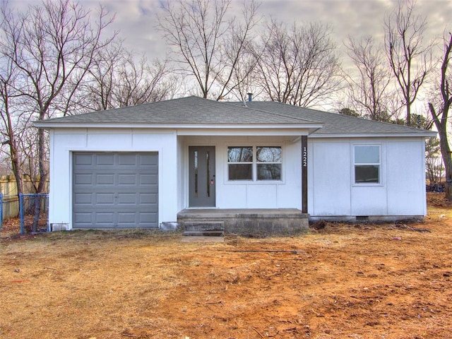 ranch-style home with crawl space, roof with shingles, fence, and an attached garage