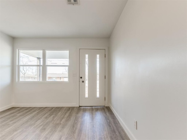 entrance foyer with baseboards, visible vents, and light wood finished floors