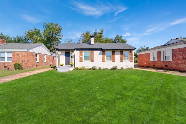 ranch-style home with a chimney and a front yard