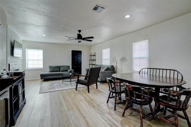 dining room with recessed lighting, a ceiling fan, baseboards, visible vents, and light wood-style floors